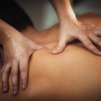 physiotherapist,massaging,male,patient,with,injured,shoulder,blade,muscle.,sports