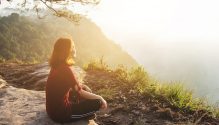 healthy,girl,relaxing,on,mountain,with,sunlight,flaring,in,tropical
